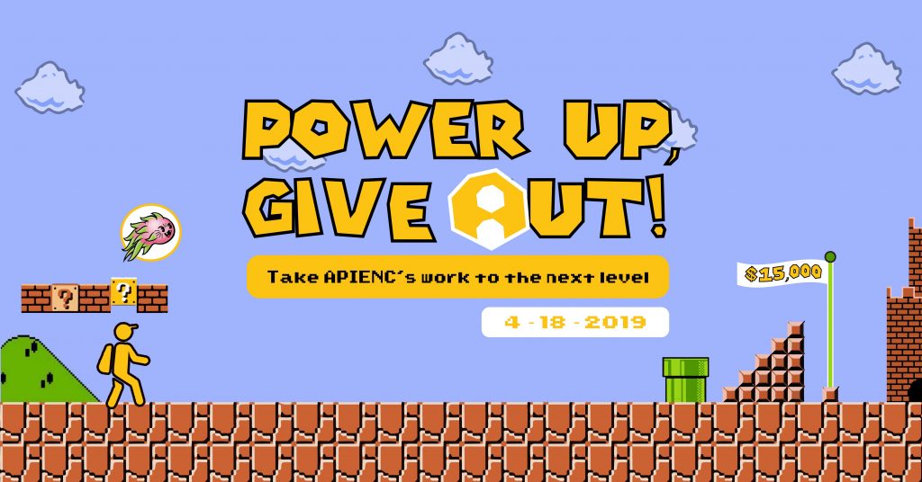 [image description: a wide graphic that looks like a retro video game. the background is a blue sky, the ground is brown blocks, and in the foreground are different video game elements like ?-boxes, and a green pipe. a yellow character gets a powerup in the shape of a dragon fruit. text reads: "Power Up, Give OUT!" with the 'o' as the APIENC logo. The goal flag reads "$15,000"]